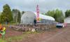 Gail Thompson with the new greenhouse in Tofte. Photo courtesy of Sawbill Garden Center